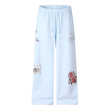 Détail produit — Pantalon de jogging évasé taille basse pour femme, ceinture rayée brodée, coupe ajustée décontractée